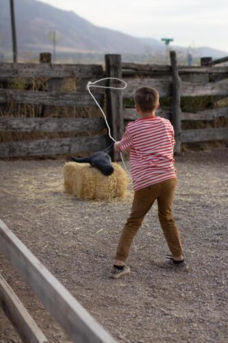 Child roping a steer head in the Kiddie Corral.